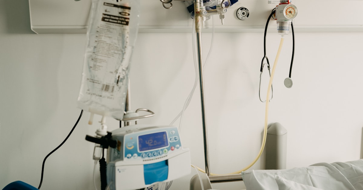 A hospital room with a bed and medical monitoring equipment