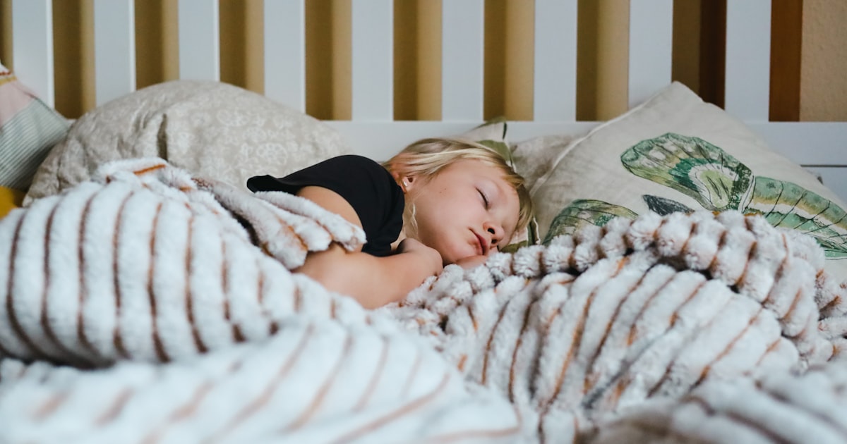 Child sleeping peacefully in bed